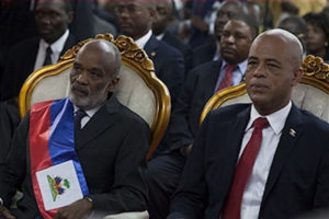 On May 14, 2011, President Préval prepares to pass the presidential sash to his successor Michel Martelly, who won power through an “electoral coup d’état.”