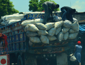 Charbon is put into large sacks then transported to Haiti’s cities by trucks like this one, being unloaded in Pétionville. Credit: UN Photo 