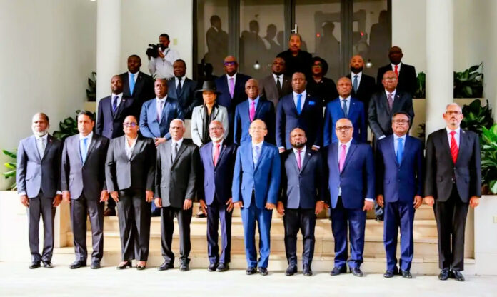 Nine CPT members with PM Didier Fils Aime on right