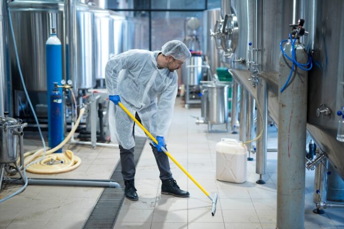 professional-industrial-cleaner-protective-uniform-cleaning-floor-food-processing-plant_342744-1209