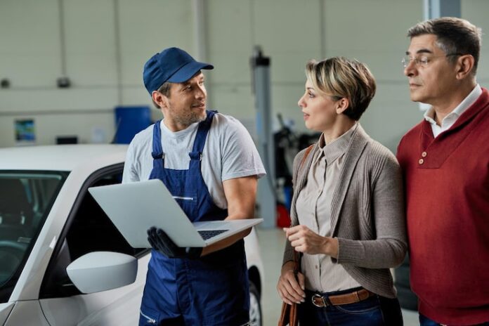 auto-repairman-communicating-with-his-customers-while-using-laptop-workshop_637285-7782-1